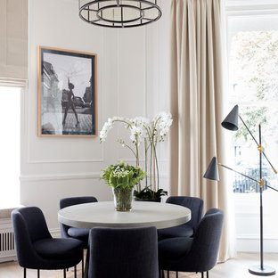 Inspiration for a medium sized traditional open plan dining room in London with beige walls, laminate floors and beige floors.