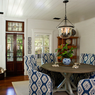 Example of a small beach style medium tone wood floor dining room design in Charleston with white walls