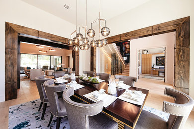 Example of a large trendy medium tone wood floor and brown floor enclosed dining room design in Dallas with white walls and no fireplace