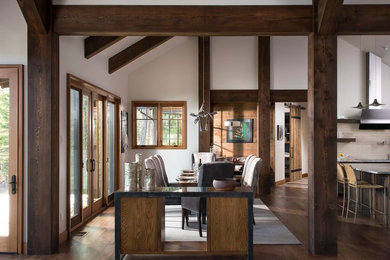 Example of a large mountain style dark wood floor great room design in Orange County with white walls and no fireplace