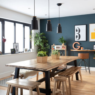 This is an example of a scandinavian kitchen/dining room in Other with white walls, light hardwood flooring and beige floors.