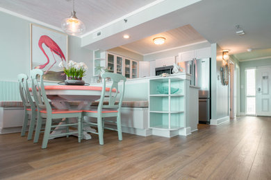 Example of a small beach style vinyl floor and yellow floor breakfast nook design in Wilmington with green walls