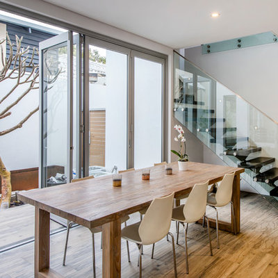 Inspiration for a contemporary medium tone wood floor dining room remodel in Perth
