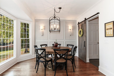 Inspiration for a mid-sized farmhouse medium tone wood floor kitchen/dining room combo remodel in Chicago with white walls and no fireplace