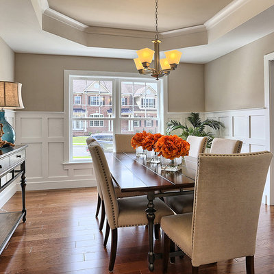 Dining room - large traditional medium tone wood floor and brown floor dining room idea in Other with no fireplace and gray walls