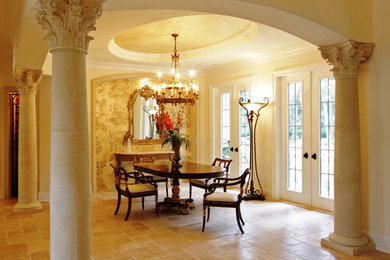 Inspiration for a small mediterranean travertine floor dining room remodel in Jacksonville with beige walls