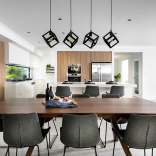 Contemporary open plan dining in Perth with white walls and grey floor.