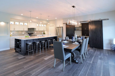 Dining room - mid-sized transitional medium tone wood floor and gray floor dining room idea in Calgary with beige walls