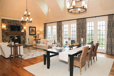 Medium sized farmhouse open plan dining room in DC Metro with beige walls, light hardwood flooring, a standard fireplace and a stone fireplace surround.