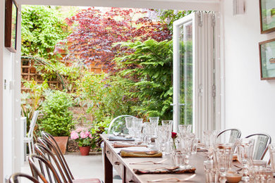 Photo of a shabby-chic style dining room in London.