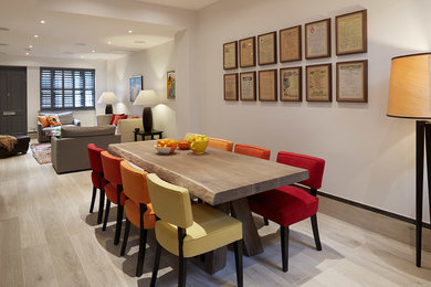 This is an example of a medium sized contemporary open plan dining room in London with grey walls and porcelain flooring.