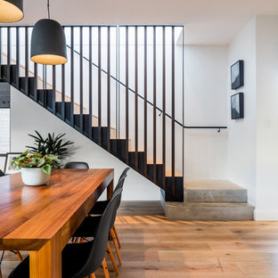 Design ideas for a contemporary dining room in Sydney with white walls, medium hardwood floors and brown floor.