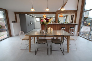 Photo of a rustic dining room in Other with concrete flooring.