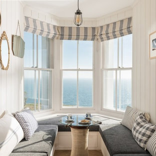 Photo of a medium sized coastal dining room in Cornwall with beige walls.