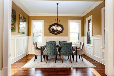 Inspiration for a large timeless medium tone wood floor dining room remodel in Charlotte with yellow walls