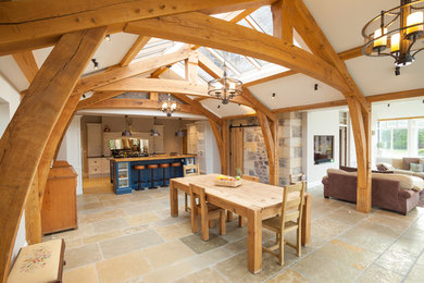 Large rural open plan dining room in Other with beige walls and beige floors.