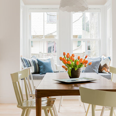 Dining room - scandinavian light wood floor dining room idea in Boston with white walls