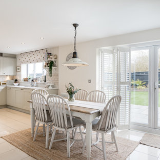 Photo of a medium sized rural kitchen/dining room in Other with beige walls, porcelain flooring, beige floors and no fireplace.