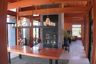 This is an example of a large modern enclosed dining room in San Francisco with brown walls, porcelain flooring, no fireplace and beige floors.