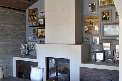 Foto de comedor contemporáneo de tamaño medio cerrado con paredes grises y todas las chimeneas