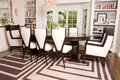 Inspiration for a mid-sized contemporary medium tone wood floor enclosed dining room remodel in Los Angeles with white walls