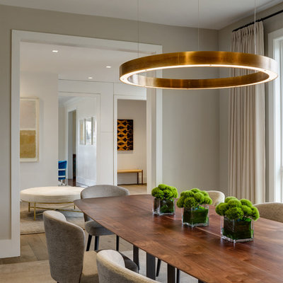 Trendy beige floor and dark wood floor dining room photo in New York with beige walls