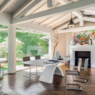 Inspiration for a large industrial dark wood floor great room remodel in Philadelphia with beige walls, a standard fireplace and a metal fireplace