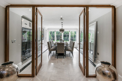 This is an example of a medium sized traditional enclosed dining room in Surrey with grey walls and white floors.