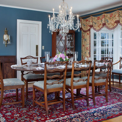 Large elegant medium tone wood floor enclosed dining room photo in Orlando with blue walls
