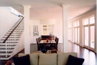 Inspiration for a large transitional dark wood floor great room remodel in Charlotte with white walls and no fireplace