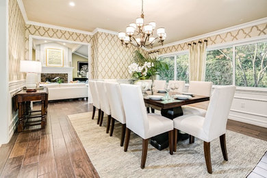 Example of a large classic dark wood floor and brown floor enclosed dining room design in Orange County with beige walls and no fireplace