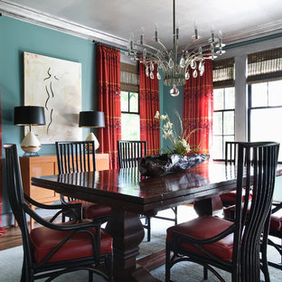 Eclectic medium tone wood floor and brown floor enclosed dining room photo in Other with blue walls