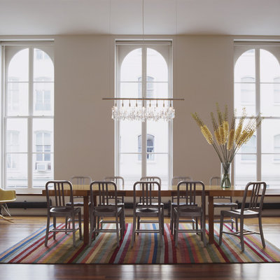 Huge trendy dark wood floor great room photo in New York with white walls