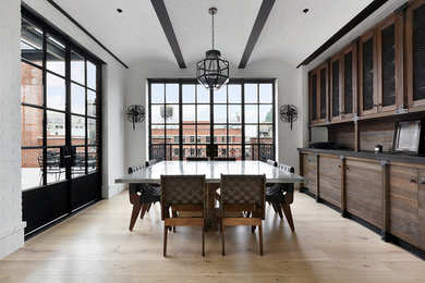 Inspiration for a modern light wood floor and brown floor dining room remodel in New York with white walls