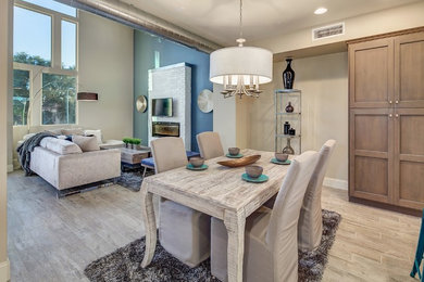 Mid-sized trendy ceramic tile great room photo in Phoenix with beige walls and a brick fireplace