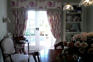 Photo of a large shabby-chic style enclosed dining room in Manchester with grey walls, carpet and no fireplace.