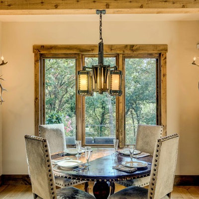 Dining room - rustic light wood floor dining room idea in Other with beige walls and no fireplace