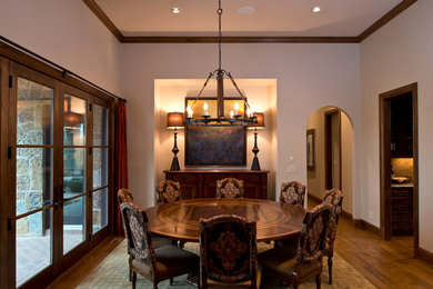 Inspiration for a mid-sized mediterranean dark wood floor enclosed dining room remodel in Wichita with beige walls