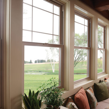 Tuscany Series single hung windows with perimeter grids in tan dining room