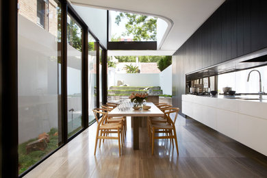 This is an example of a contemporary kitchen/dining room in Sydney.