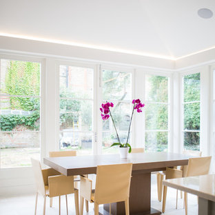 Medium sized classic kitchen/dining room in London with limestone flooring and beige floors.