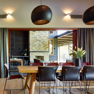 This is an example of a contemporary dining room in Sunshine Coast with white walls, medium hardwood floors and brown floor.