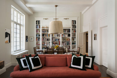 Photo of a medium sized traditional open plan dining room in New York with white walls, dark hardwood flooring, a standard fireplace, a wooden fireplace surround and brown floors.