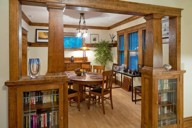 Example of a mid-sized arts and crafts light wood floor and beige floor enclosed dining room design in Other with white walls and no fireplace