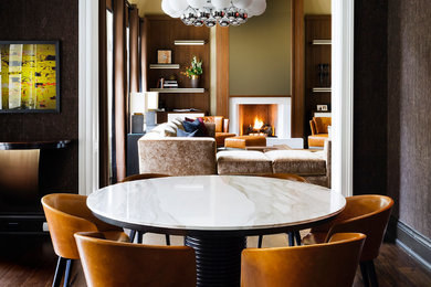 Trendy dark wood floor enclosed dining room photo in Toronto with brown walls