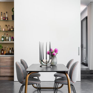 Eclectic open plan dining in Perth with white walls, concrete floors and grey floor.