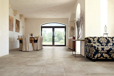 Esempio di una grande sala da pranzo aperta verso il soggiorno design con pareti beige e pavimento con piastrelle in ceramica