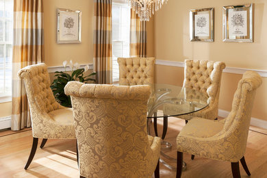 Mid-sized transitional light wood floor enclosed dining room photo in Boston with yellow walls and no fireplace