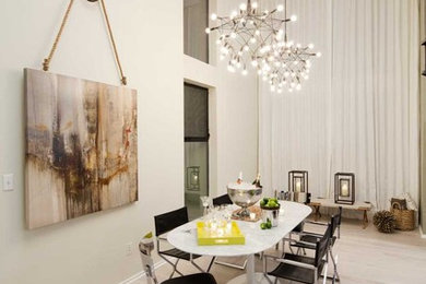 Example of a trendy light wood floor dining room design in Los Angeles with beige walls