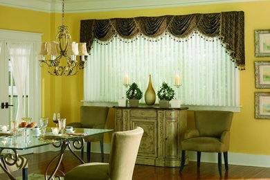 Dining room - mid-sized contemporary medium tone wood floor dining room idea in Denver with yellow walls